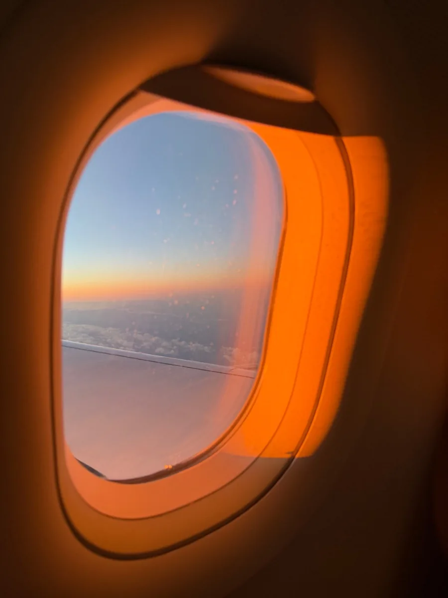 Airplane window at sunset